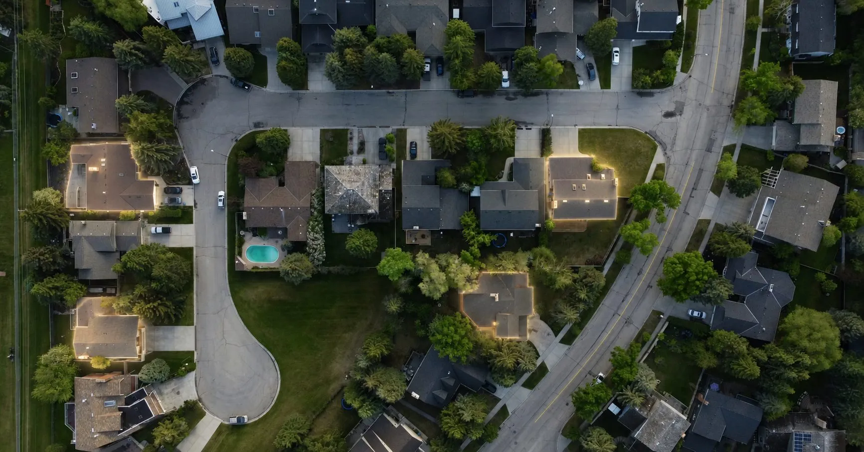 An aerial view of a suburban street of homes